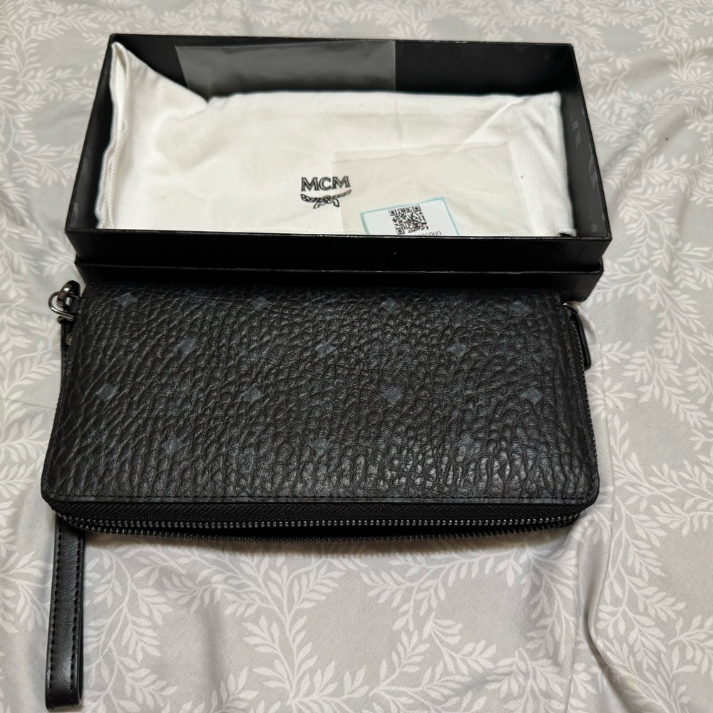 MCM zipper/wristlet wallet black. Opened but not used brand new.